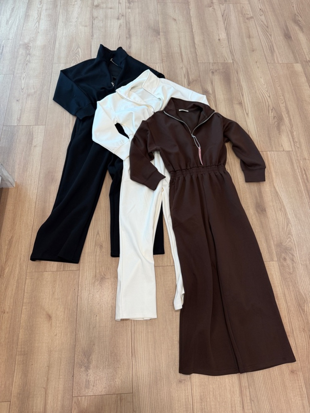 Three Long-Sleeve Zip Jumpsuits in Black, Cream & Brown